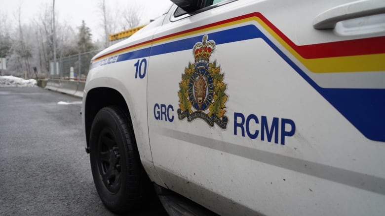 A logo on the door of an RCMP vehicle is pictured on a cloudy day.