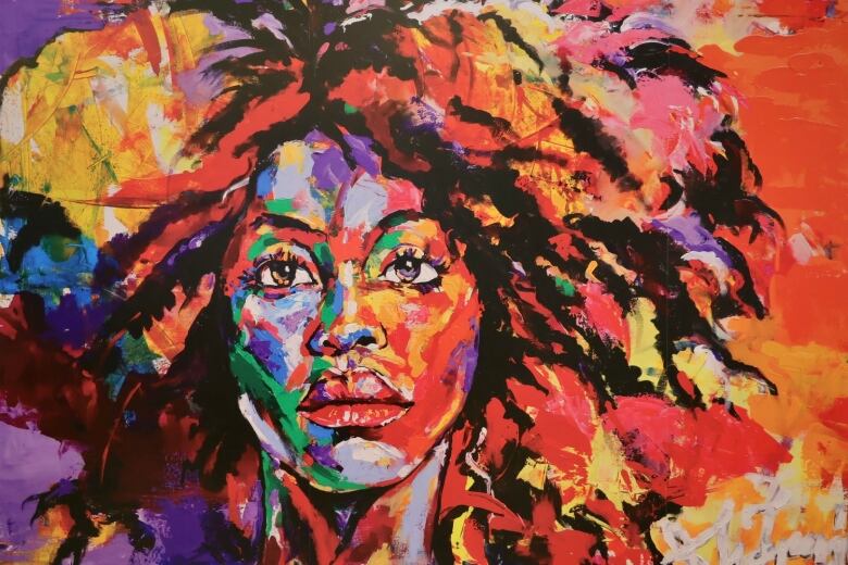 A vibrant painting of a woman. 