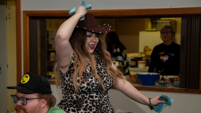 A drag performer dances through the audience.