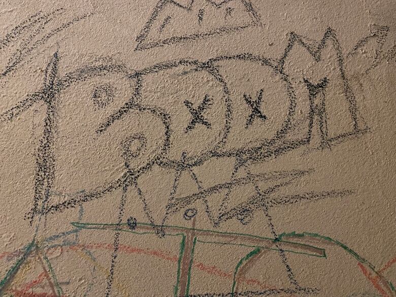 A child's drawing features the word 'BOOM.'