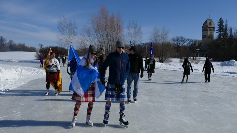 Skaters in kilts glide across the ice.