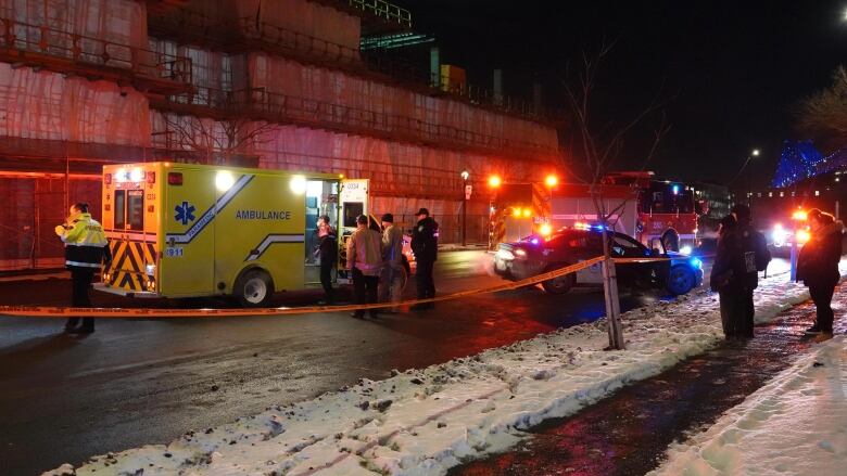 Police and ambulance vehicles are gathered.