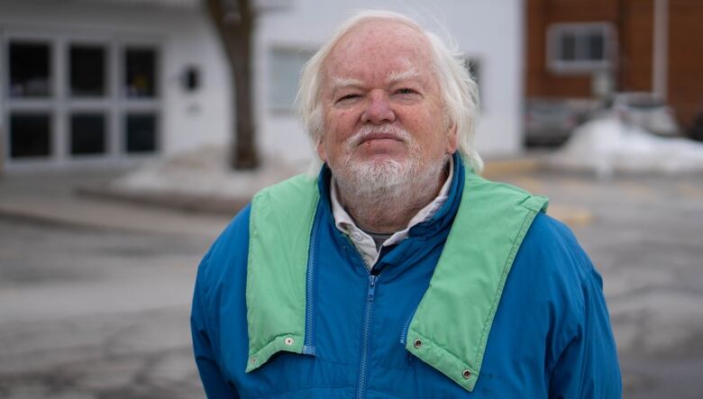 A man poses for a photo outside in winter.