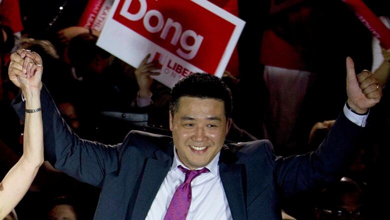 Candidate Han Dong celebrates with supporters while taking part in a rally in Toronto on Thursday, May 22, 2014.