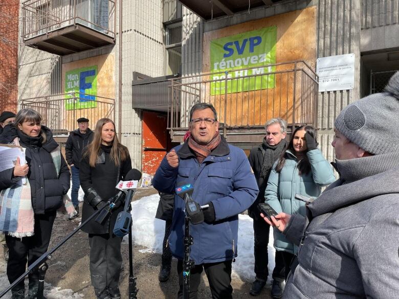 People stand in front of a building.