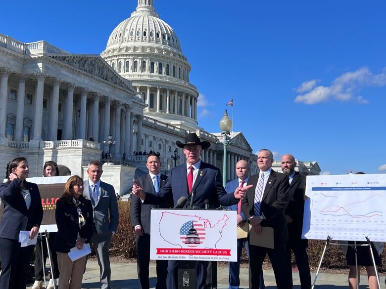 Lawmakers speak at podium outside U.S. Capitol. 