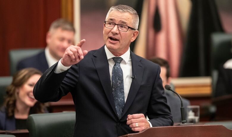 Alberta Finance Minister Travis Toews gestures with his right hand as he delivers the 2023 budget, in Edmonton on Tuesday, February 28, 2023.