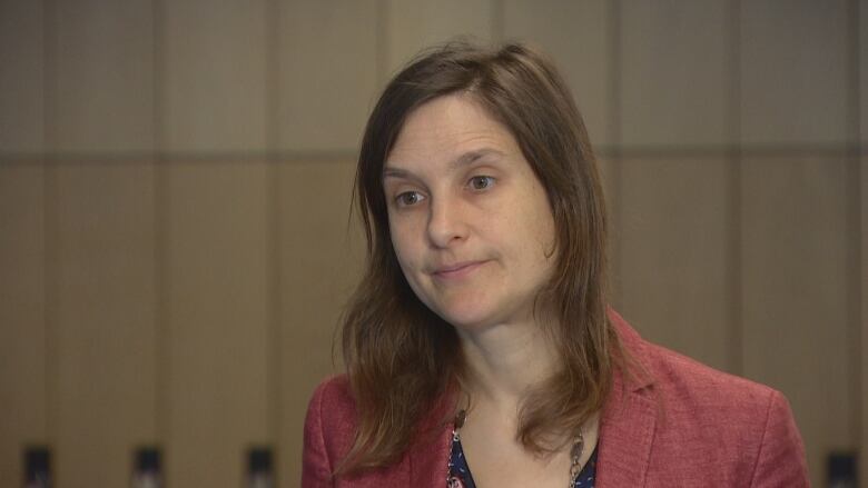 A woman, Claire Celerier, is shown being interviewed at the CBC building in Toronto.