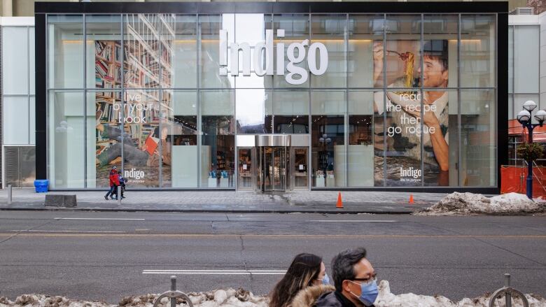 Pedestrians walk past an Indigo store in Torontos downtown Yorkville neighbourhood on March 1, 2023. 