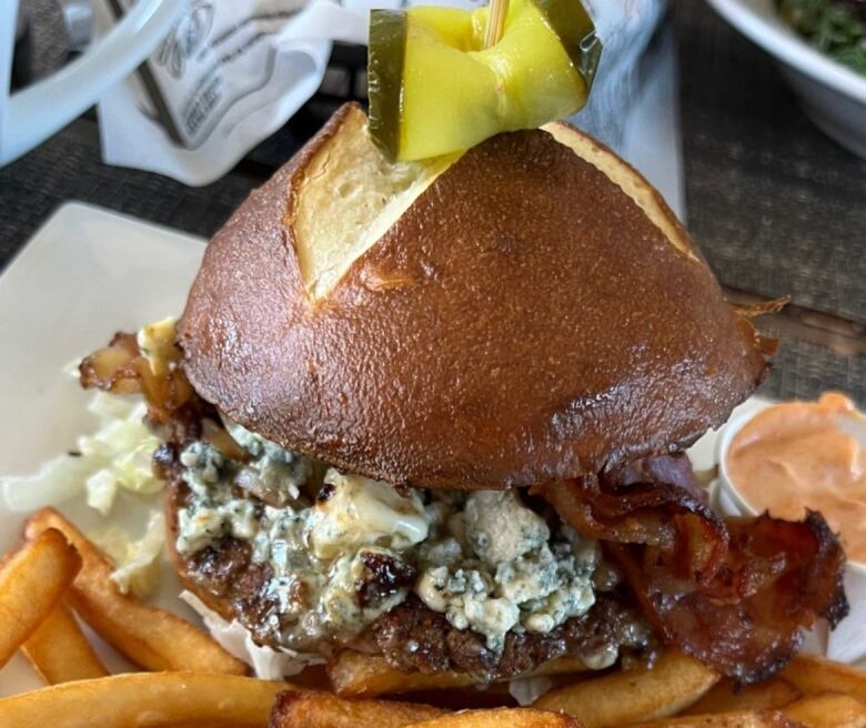 A photo of a burger and fries on a plate.