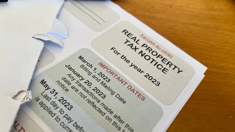 A property tax notice with an envelope on top of it