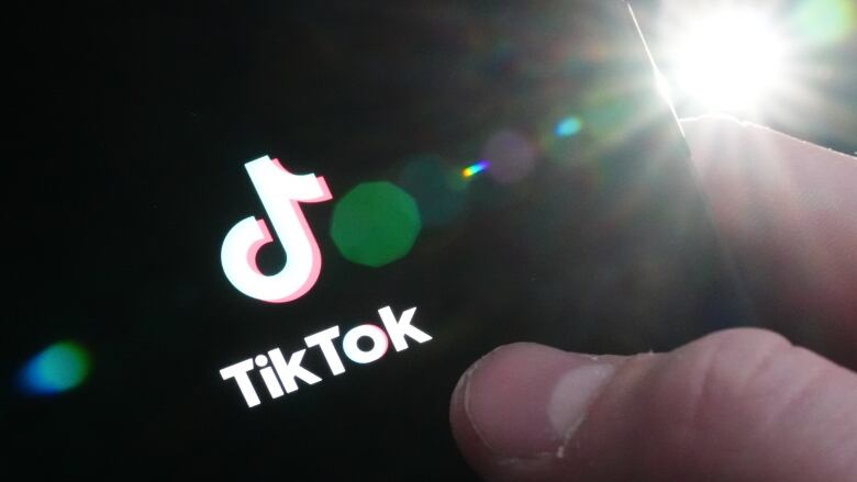 The TikTok startup page is displayed on an iPhone in Ottawa on Monday, Feb. 27, 2023. The federal government is banning TikTok from its mobile devices just days after federal and provincial privacy commissioners launched an investigation into the social media platform. 