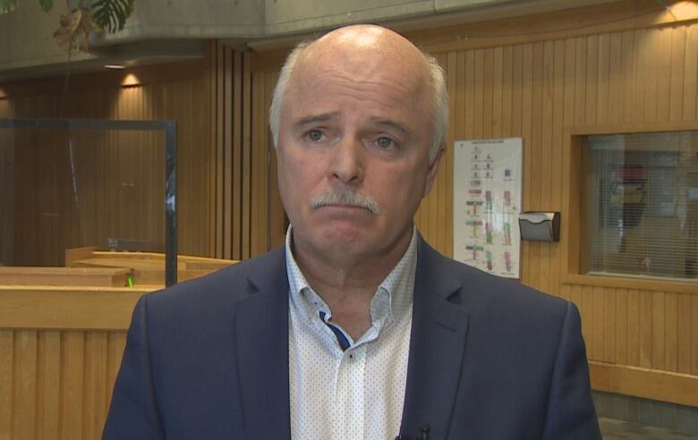 A middle-aged man stands in the lobby of the west block of the Confederation Building in St. John's while speaking with a CBC reporter.