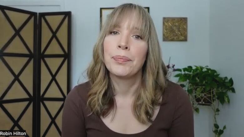 Women sitting in her living room on a zoom interview