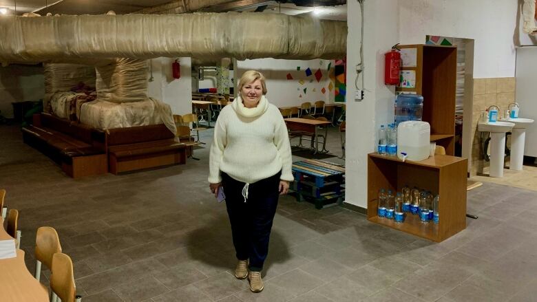 Olha Tymoshenko, 63, stands in the basement shelter she helped prepare in Kyiv School No. 309. 'We started to organize the building, fixing the question of drinking water for all the people, security measures, etcetera.'