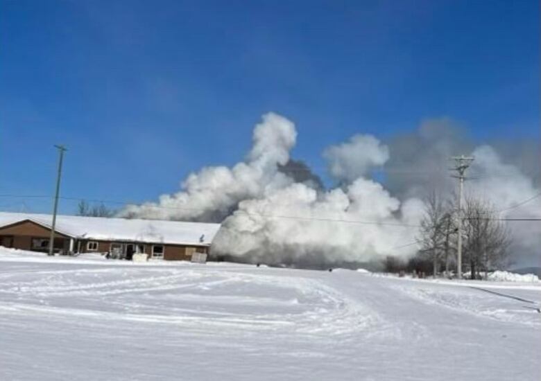 Smoke billows from a building.