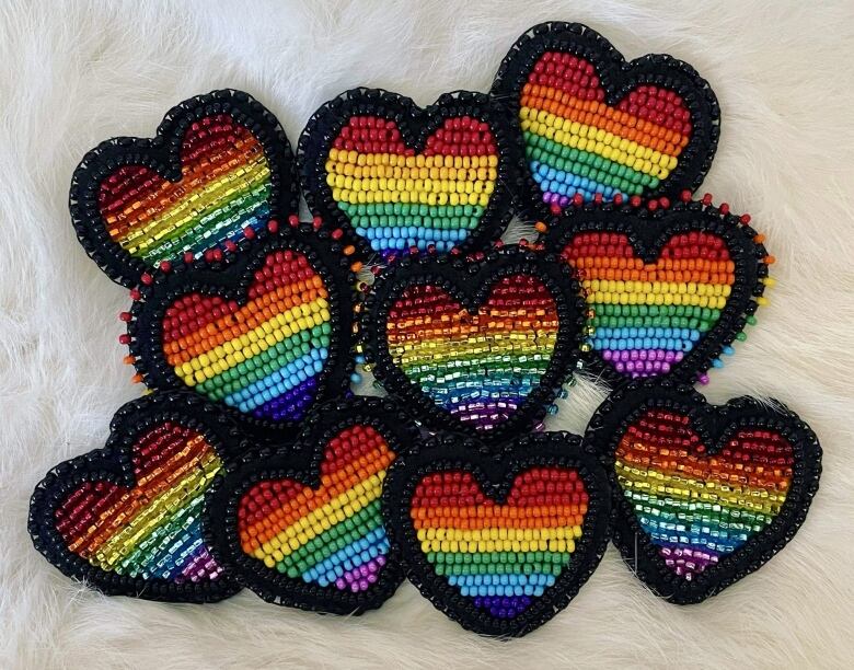 Beaded hearts with a rainbow pattern.