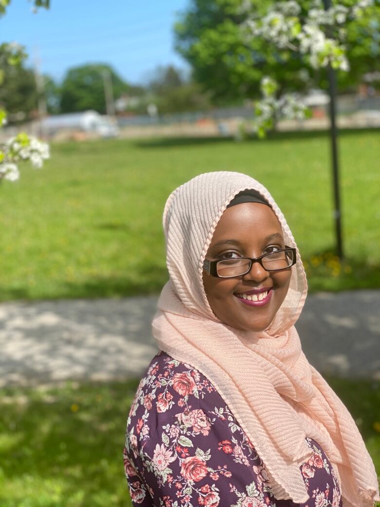 Hibaq Warsame stands in a park.