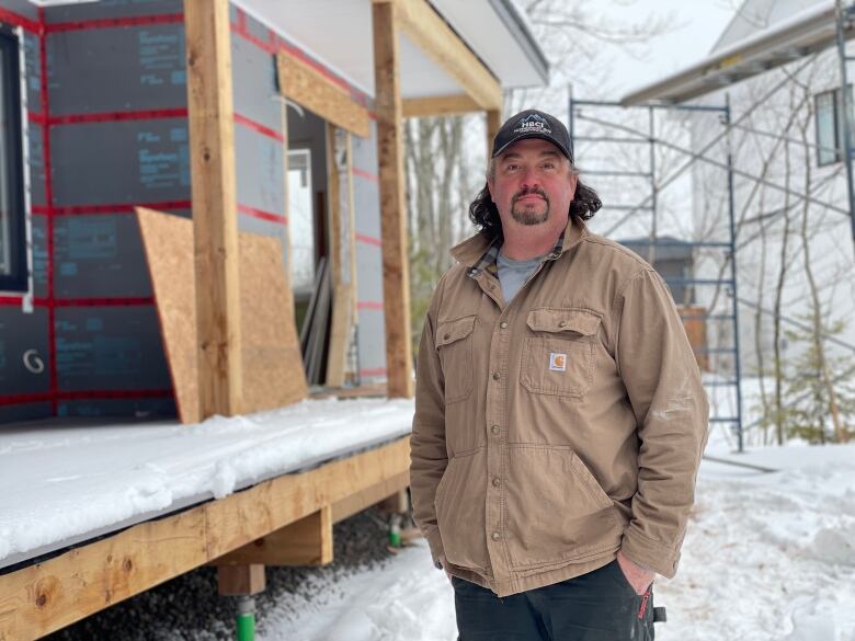 Andrew Nelson pictured outside house under construction