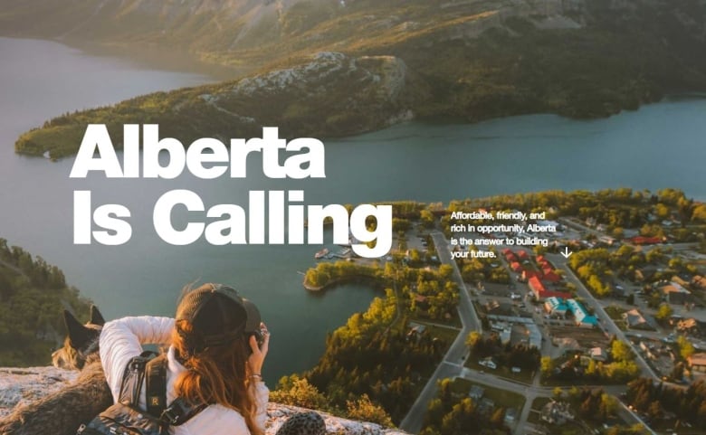 The homepage of the Alberta is Calling website is seen. It shows a woman with a dog on a cliff while she take a picture of a small town below.