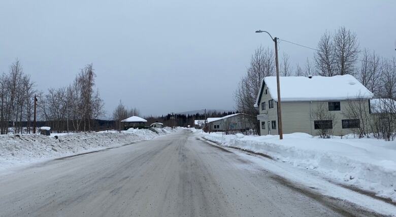 A view down an empty residential street in a small town on a winter day.