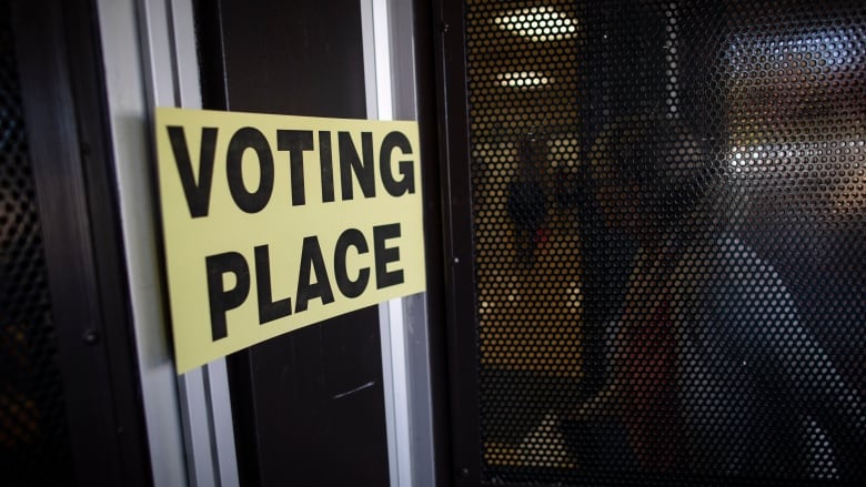 People are pictured in line at a voting station at Semiahmoo Secondary in Surrey, British Columbia on Saturday, October 15, 2022. 