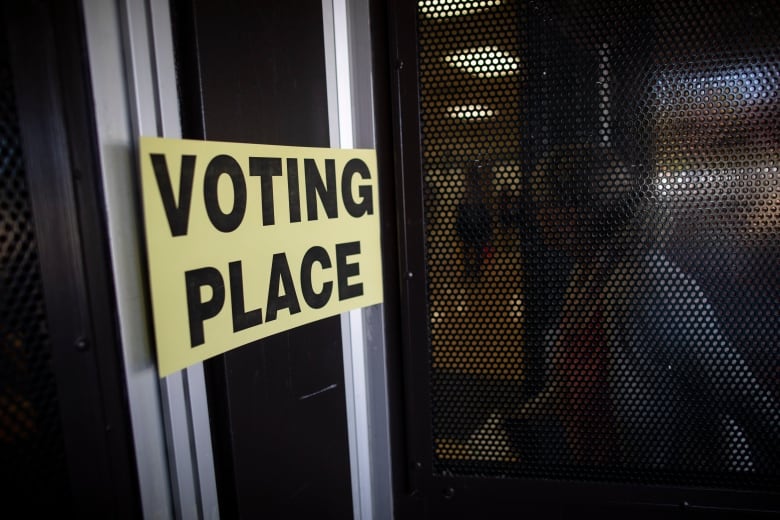 People are pictured in line at a voting station at Semiahmoo Secondary in Surrey, British Columbia on Saturday, October 15, 2022. 