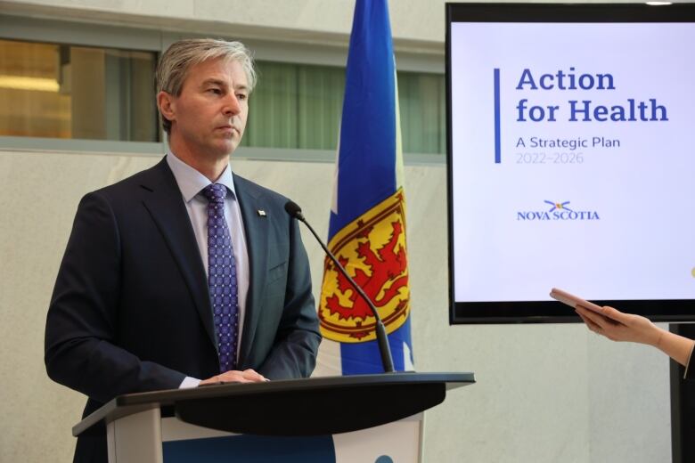 Premier Houston stands at a podium