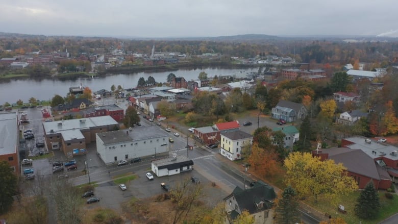 A drone shot of a small town and river.