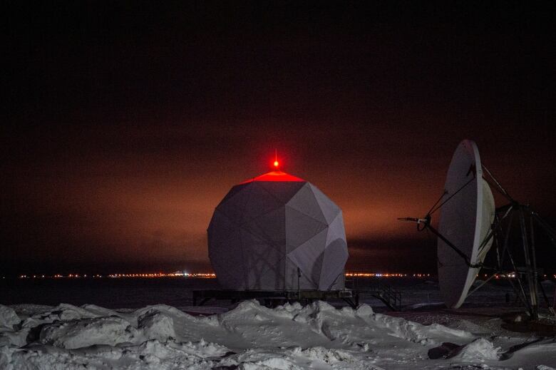 A radar dome is illuminated at the North American Aerospace Defense Command (NORAD) Point Barrow Long Range Radar Site, north of the northernmost town in the United States in Utqiagvik, Alaska, on February 3, 2023.