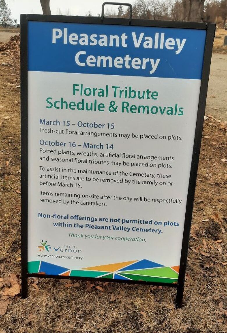 A vertical sandwich board with instructions on when floral tributes are allowed at Vernon's city owned cemetery is standing on grounds of the cemetery. 