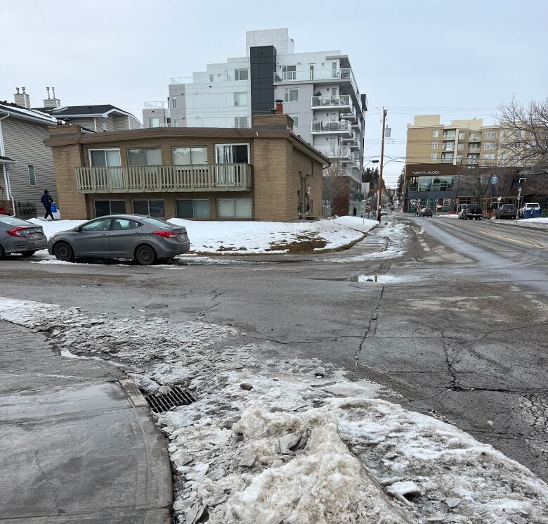 A storm drain is clear of debris and surrounded by snow.