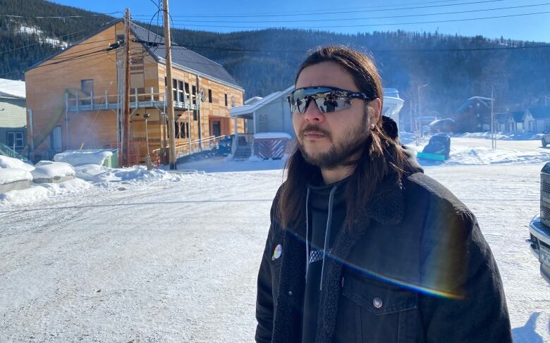 Man wearing sunglasses standing outside 