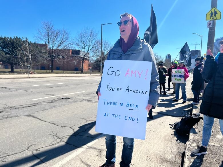 A man holding a sign that reads 