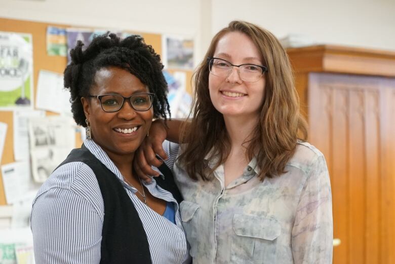 Two women smile for a photo.