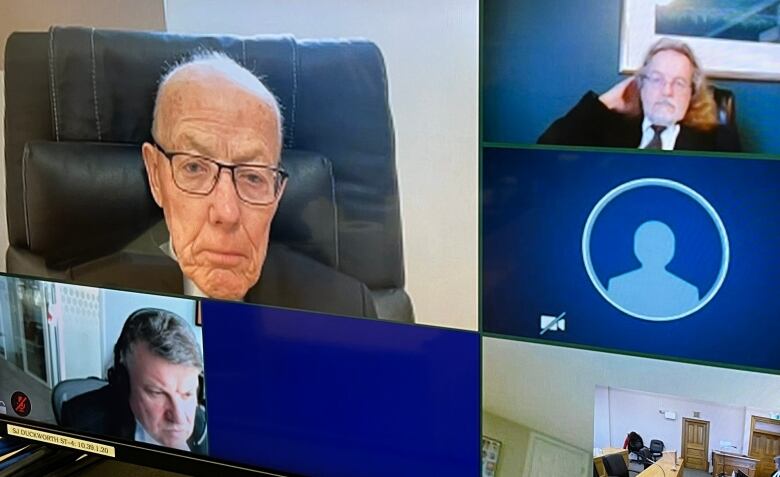 judge and lawyers appearing on a television screen.