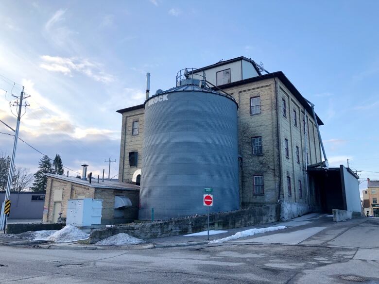 The exterior of an old mill building.