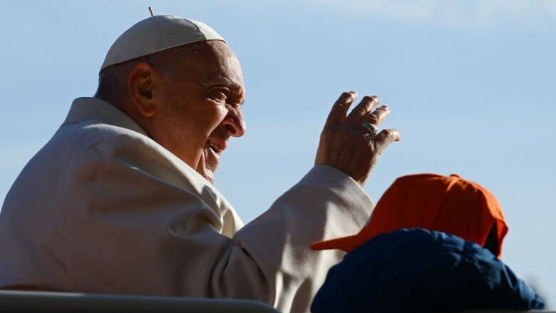 Pope Francis gesturing to crowd