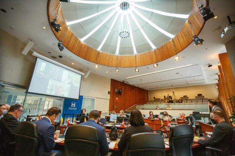 People sit around a table in council chambers