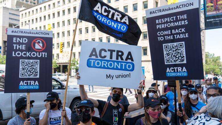 ACTRA members hold rally signs at a Toronto protest.