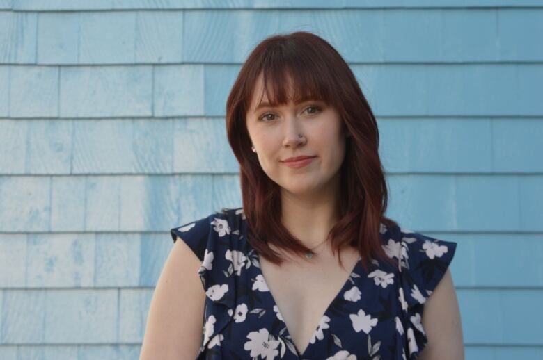 Alexandra Sorensen in front of shingled wall.