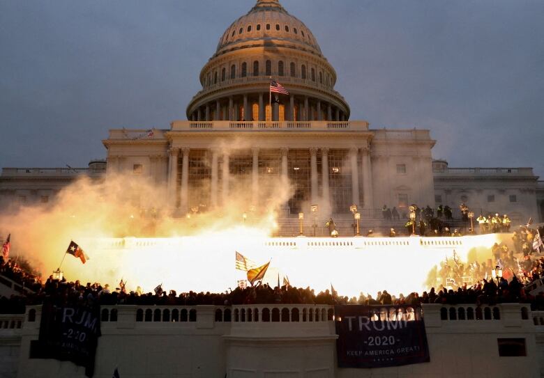 Bright flames, caused by pyrotechnics, in front of the US Capitol dome.