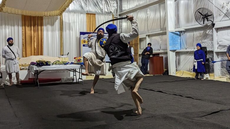 picture of two men with demonstrating a duel 