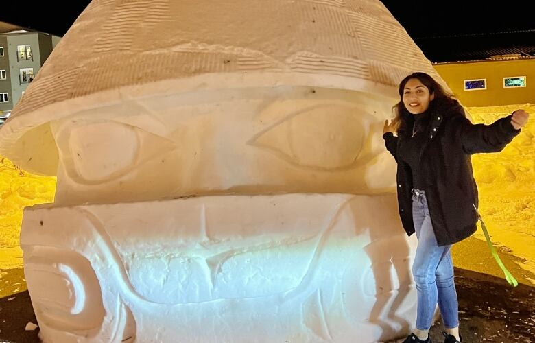 Woman standing infront of a giant ice sculpture