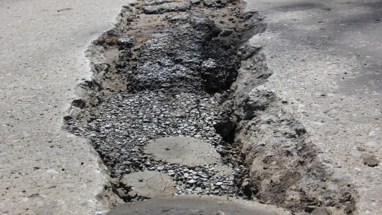 A massive pothole on a road