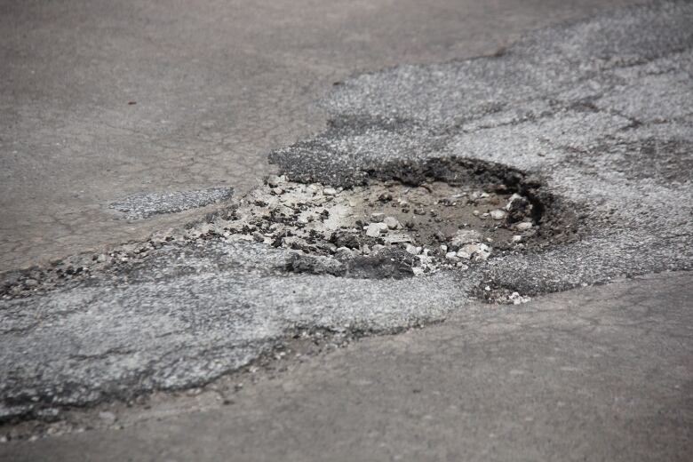 A pothole in a road