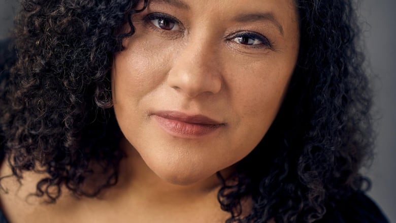 Close up portrait of a woman with dark curly hair