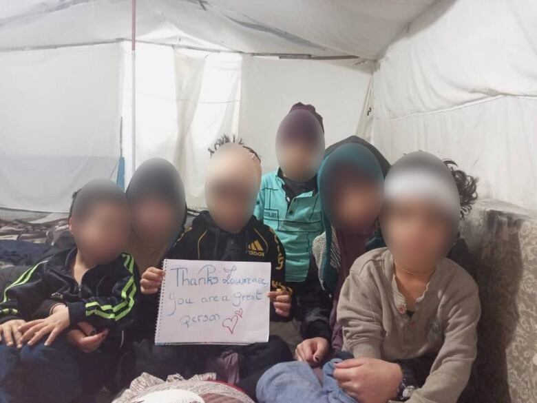 six children holding a sign 