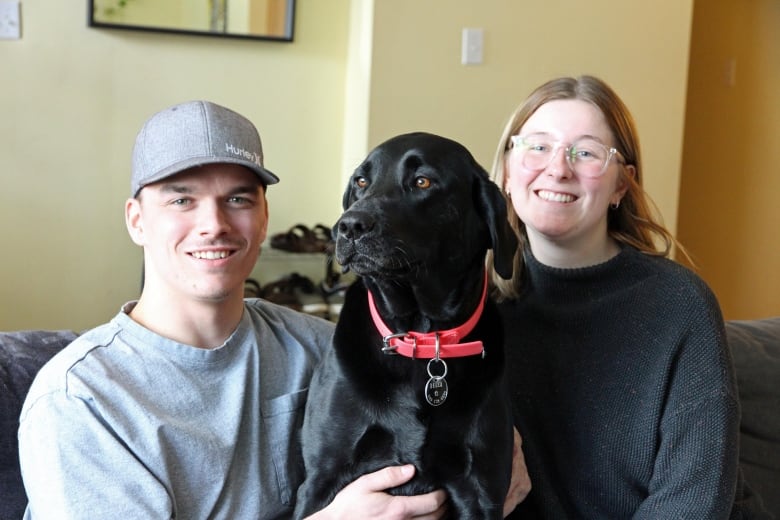 Man, woman and dog on couch