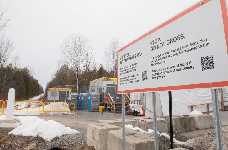 A sign advising people that entrance to Canada via Roxham road is illegal is shown on the Canada/US border in Hemmingford, Que., Saturday, March 25, 2023. 